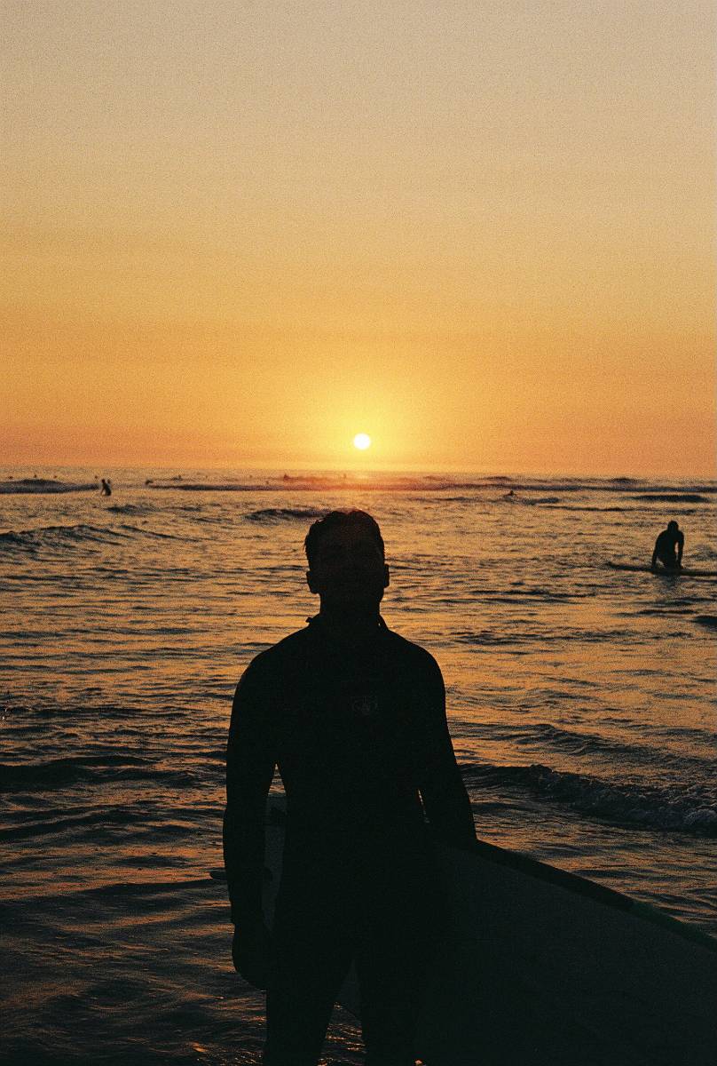 Surfer at sunset, black and white photograph