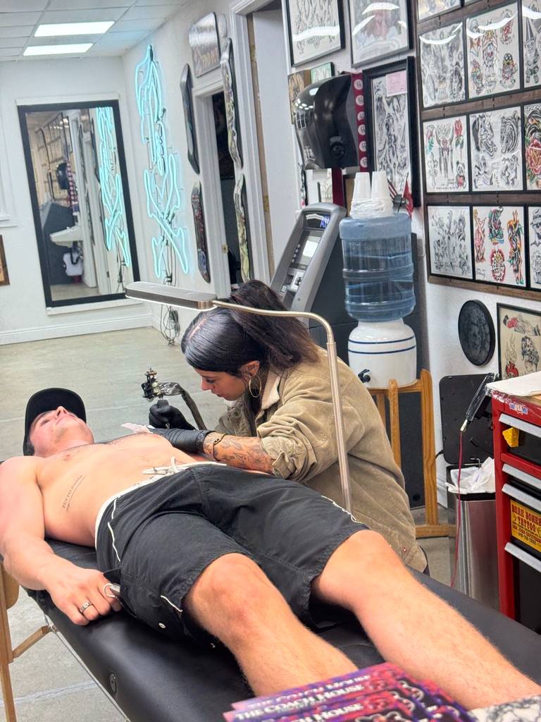 Getting the hibiscus tattooed in a California shop