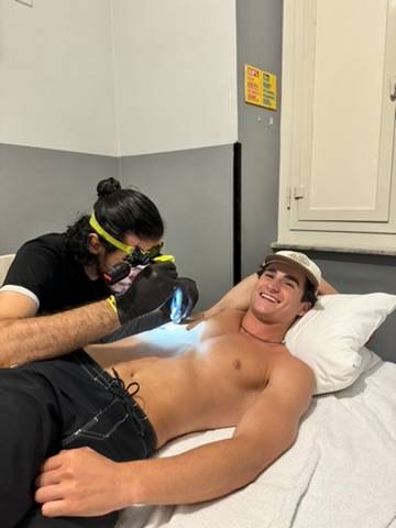 Getting tattooed on a hostel bed in Italy