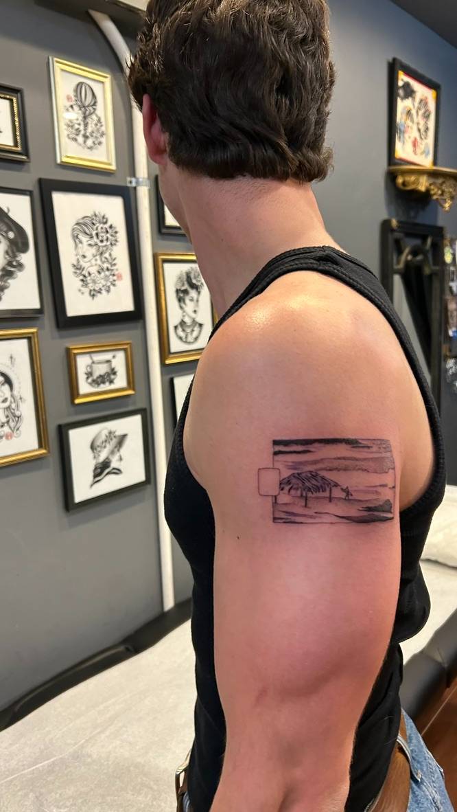 Windansea painting tattooed on the shoulder, framed